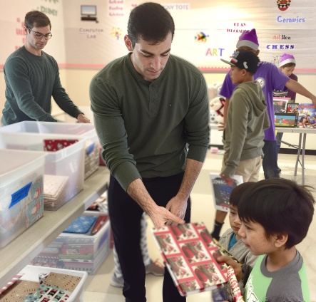 Mike and Nick Camarda distributing gift-wrapped books