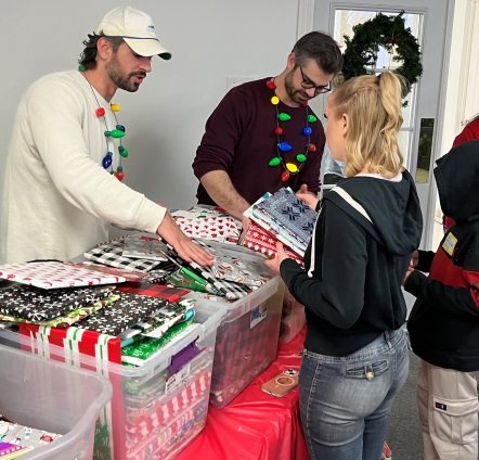 Nick and Michael Camarda distributing gift-wrapped books