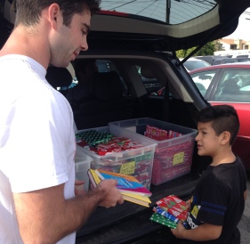 Nick Camarda distributing donated gift-wrapped books in 2015