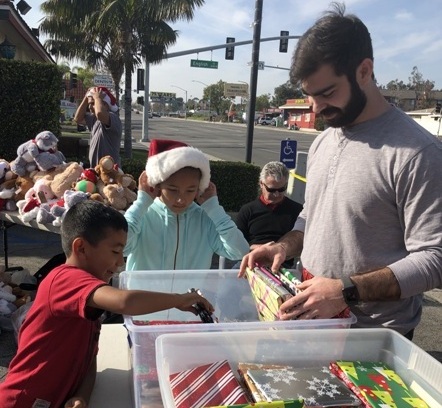 Nick Camarda distributing gift-wrapped books